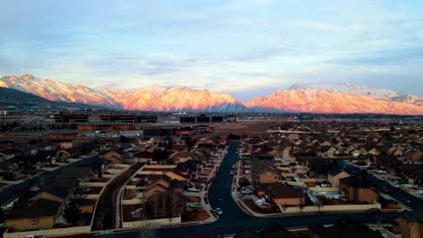 silicon slopes in lehi, utah with the sunset glowing on the snowy mountains - sliding aerial view