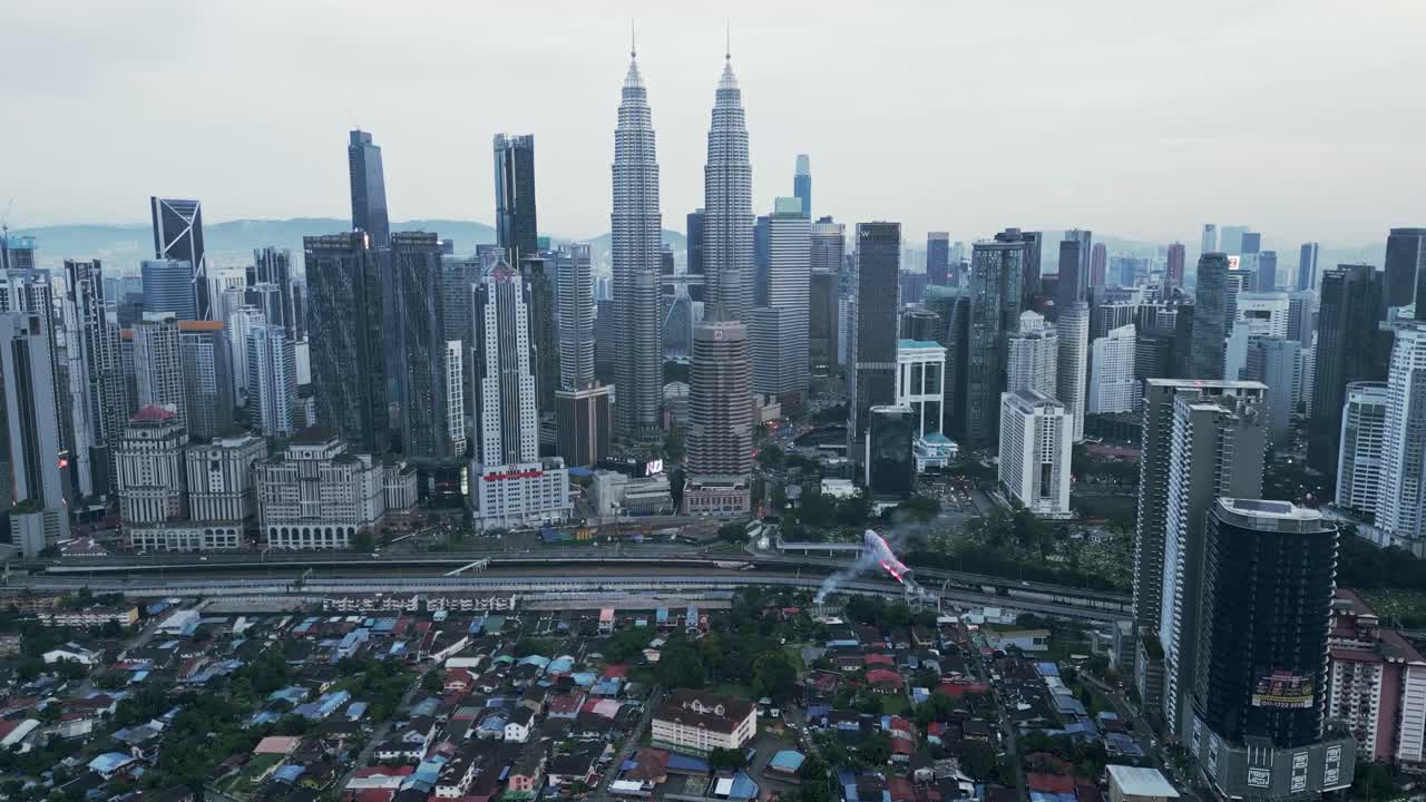 Cityscape with towering high-rises against a backdrop of cloudy skies, captured from above, panoramic dolly