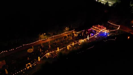 three pounds in katowice city - lakeside bar with shimmering lights reflections in water during nightime - high aerial 4k