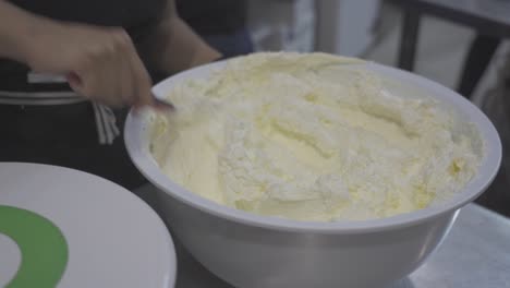 anonymous confectioner mixing sweet cream for cake