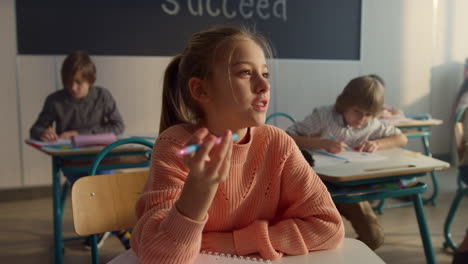 Clever-kid-raising-hand-during-lesson.-Cute-student-answering-for-question