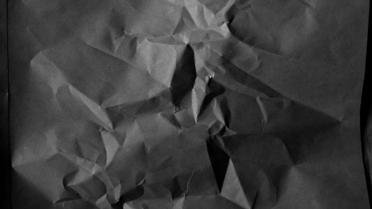 Crumpled Dark Paper Texture Background with Subtle Light Changes