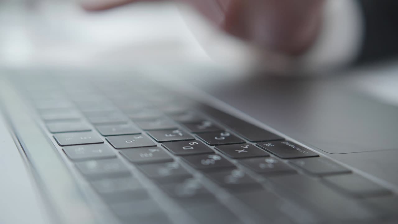 Man is typing on laptop at the office