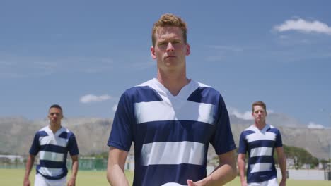 rugby players standing with ball