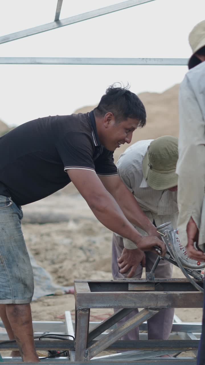 Construction workers assembling metal frame