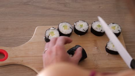 cortando perfectamente un rollo de sushi con un cuchillo afilado