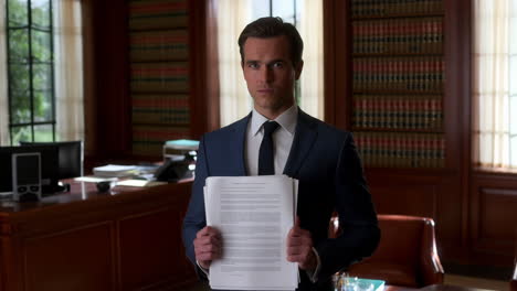 man in suit holding legal document