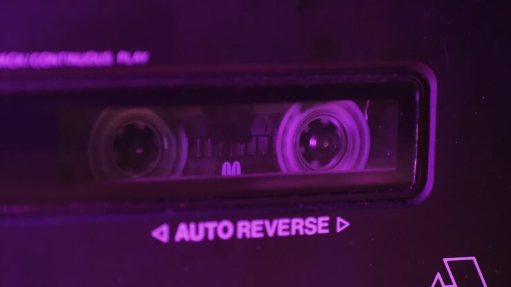 Retro radio tape recorder, audio cassette close-up. Listening to music, old radio boom box player, macro of vintage music listening.