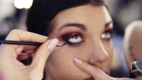 Using-special-angled-eyeliner-brush-to-apply-black-pigment-on-the-waterline.-Creating-perfect-smokey-look.