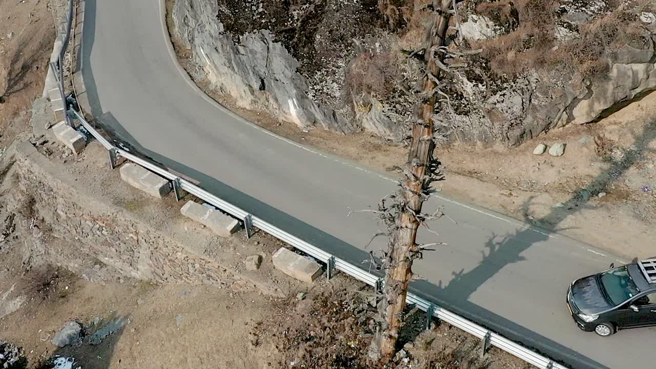 car driving through the curve of mountain view at Himalayan Road