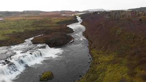 faxi waterfall and flowing river stream in nordic heath landscape