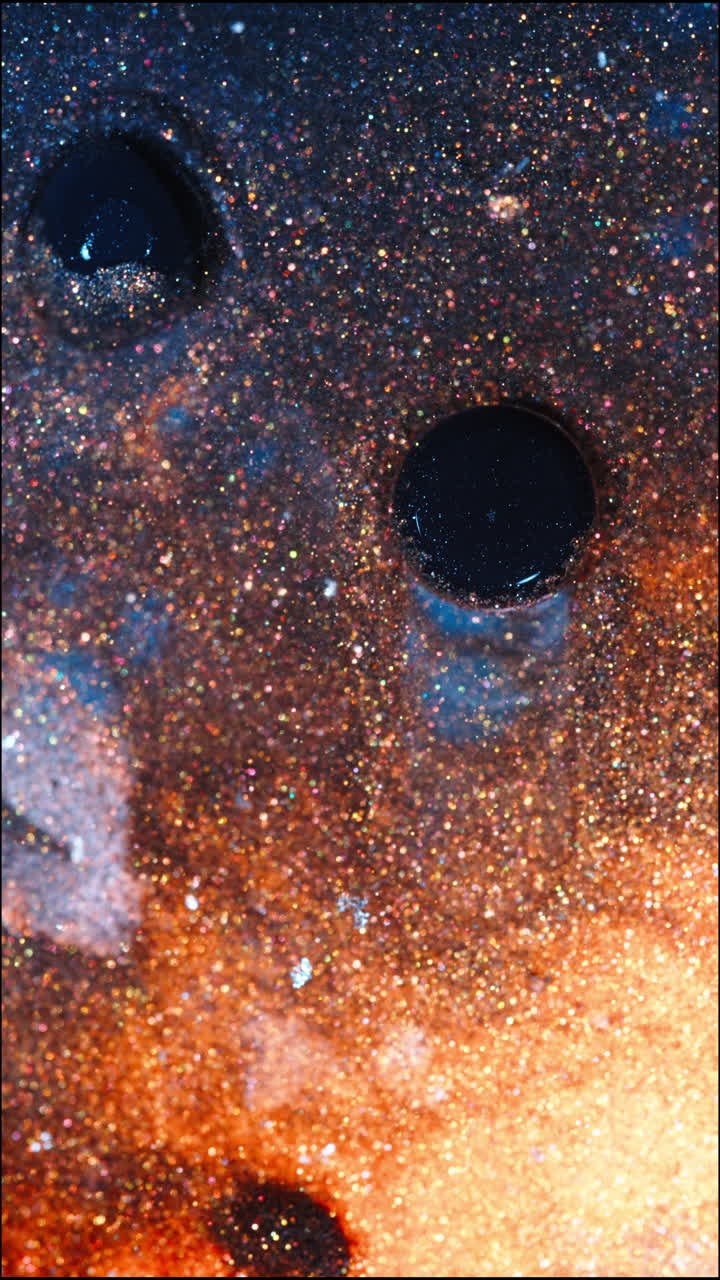 Colorful liquids mix in macro view, creating swirling textures vertically