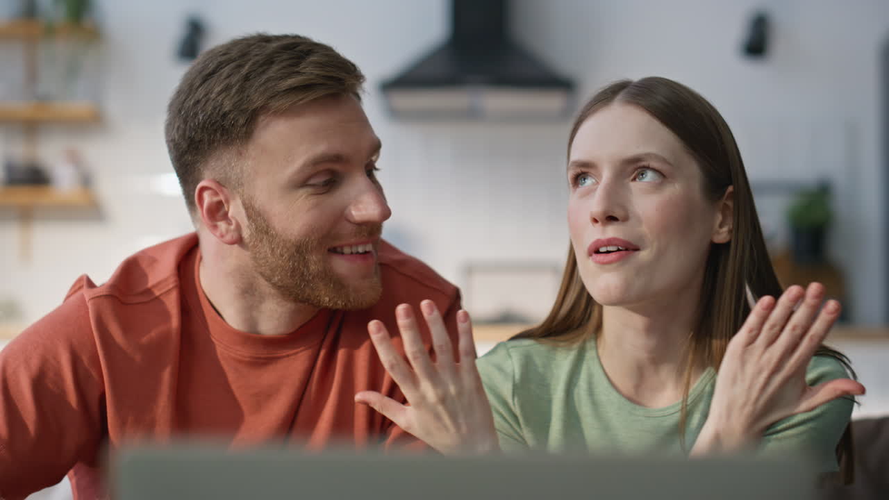 Husband wife talking video meeting looking laptop webcam at home sofa closeup