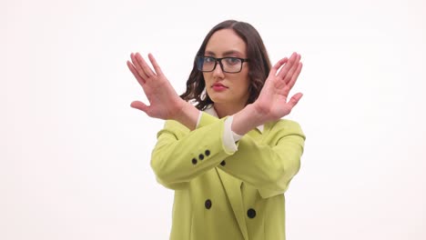 woman crosses arms in x gesture to say stop or no