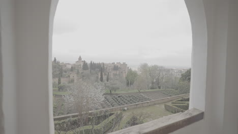 panoramic view over the gardens of the alhambra in granada spain on a cloudy day from a viewing point on log