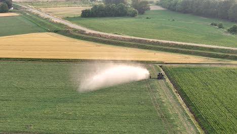 Aerial view of automated irrigation system spraying water on soybean crops in Po Valley, Italy, during springtime, ensuring proper hydration and growth