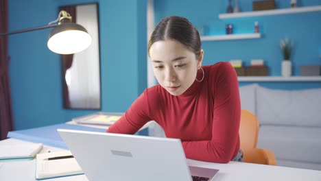 Young-Asian-woman-comes-to-her-mind-while-working-from-laptop-and-gets-stressed-and-starts-to-think.