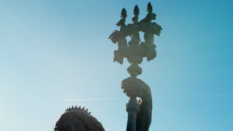 bronze statue detail against a sunny sky