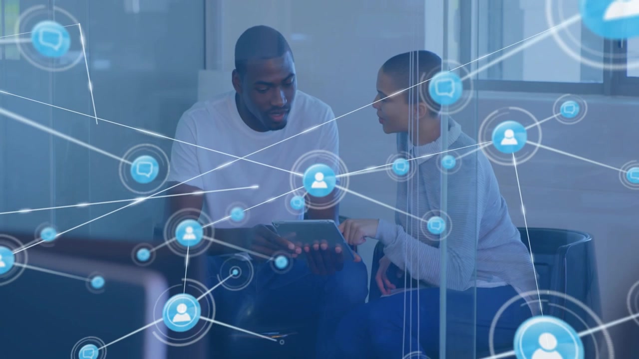 Tapping man and leaning woman working on tablet in office nook, UI appearing then expanding network