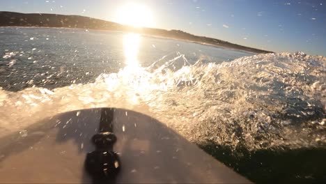 POV-slow-motion-shot-of-Handsome-guy-surfing-a-green-wave-in-Guincho,-Portugal