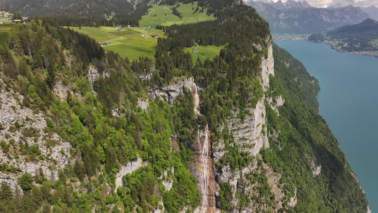 Aerial view of Seerenbach Falls dropping into the Walensee lake near Amden, Switzerland