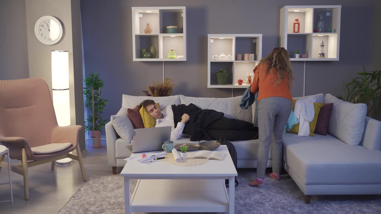 Cute Mom collects her messy son's things.