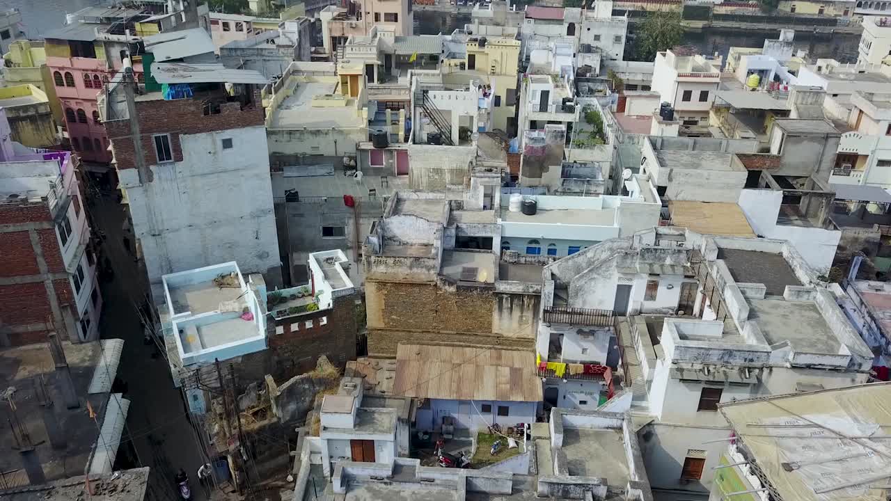 The Ancient City Of Udaipur Near The Lake Pichola In Rajasthan, India.  - aerial drone descending