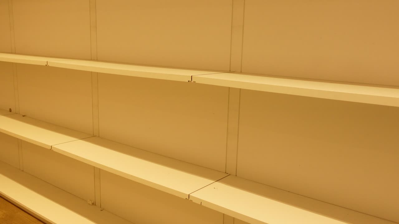 Empty White Shelves Against a Light Beige Wall