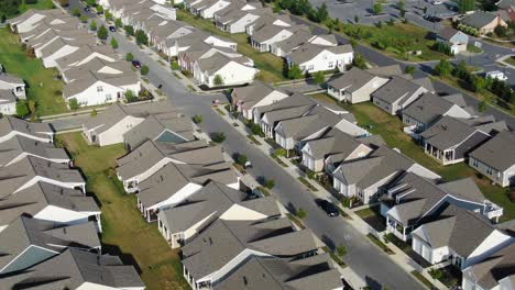 slow aerial turn reveals hundreds of identical homes, new construction, built in us suburban sprawl