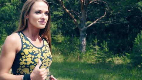 cu portrait young girl goes in for sports in the morning runs along a pine forest 1