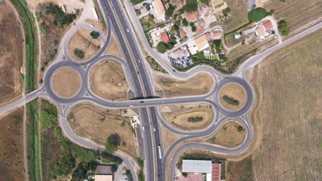 top aerial view over roundabouts with traffic and highway france summer sunny