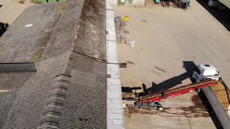 aerial view of loading potatoes through a grader machine on a farm in south east england