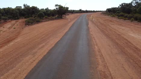 Drone-Volando-Sobre-Una-Carretera-Rural-Sellada-A-Baja-Altitud-En-El-Interior-De-Australia