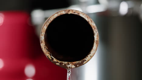 rusty water pipe with flowing water