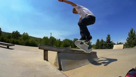 person flips their skateboard on to the rail