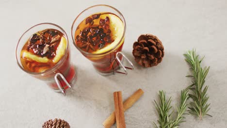 video of cups of hot tea with cinnamon and lemon over white background