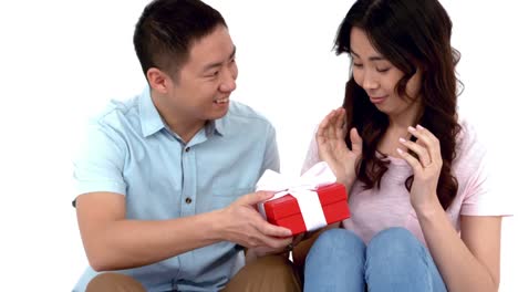 attractive young couple holding gift