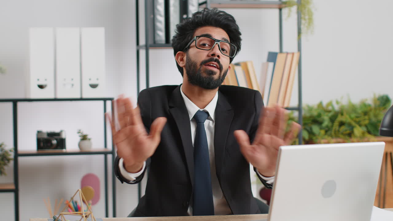 Businessman working on laptop showing stop gestuge danger rejection warning crisis prohibition