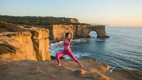 a tranquil morning yoga session on a dramatic coastal cliff with the rising sun casting warm light over an inspiring natural landscape