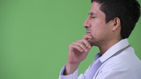 profile view of hispanic man doctor thinking