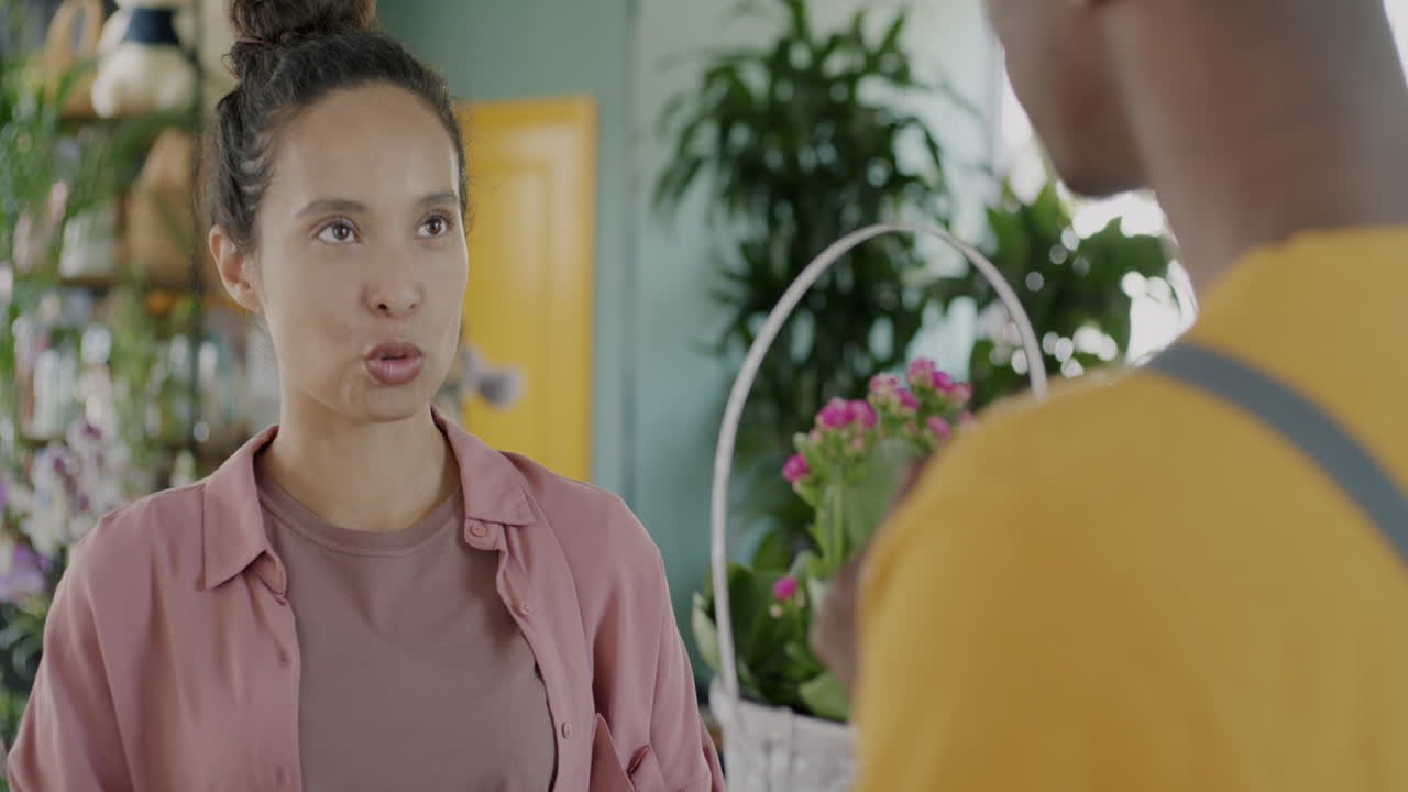 Customer interacting with florist in flower shop