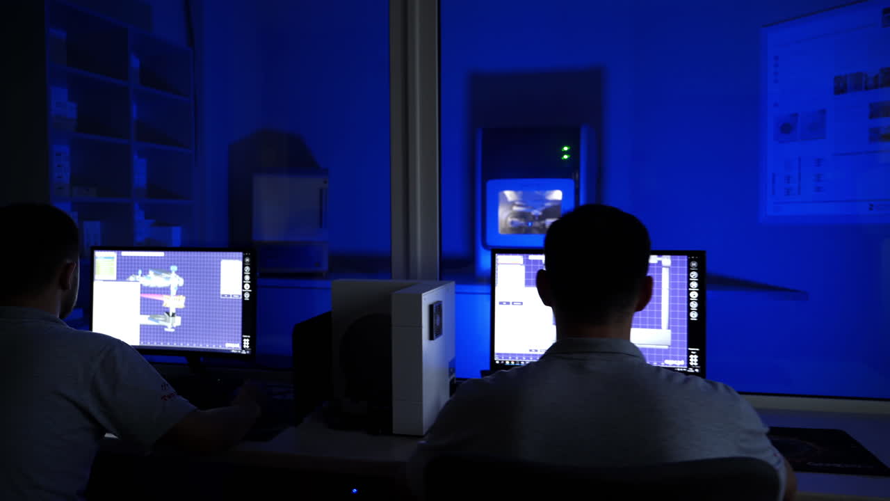 Dental technician working on tooth crown. Concentrated dental technician sitting in office, examining the model of teeth on computer