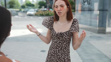 two women talking outside