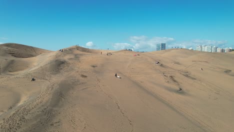 Dunes-of-Viña-del-Mar-with-several-People-Walking-around-Leaving-Marks-in-the-Sand,-Chile