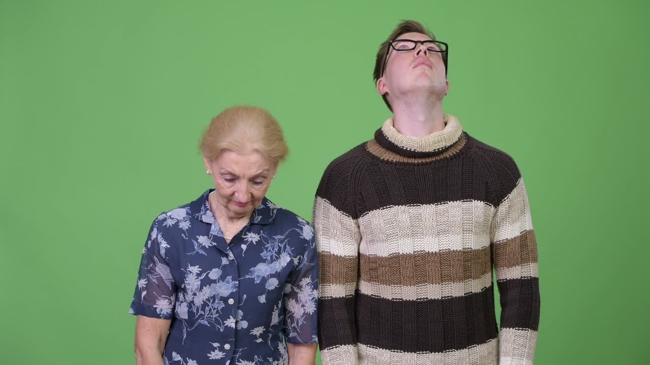 Grandmother looking down and grandson looking up together