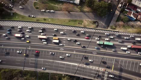 a dynamic aerial shot of heavy traffic over and under the flyover