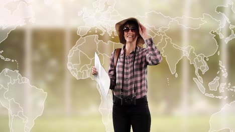 animación de una feliz mujer caucásica con sombrero con mapa sobre mapa del mundo.