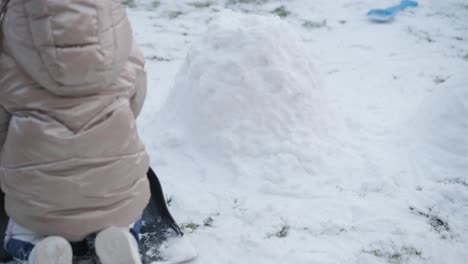 grandfather and granddaughter having fun in the snow