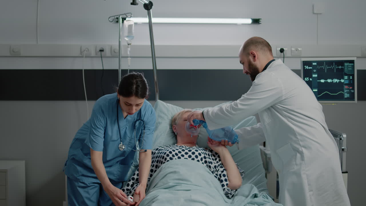Doctor and nurse using oxygen tube and oximeter on ill patient