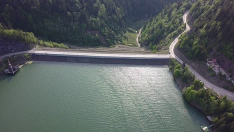 aerial backwards panning of reservoir edge with valley in the background